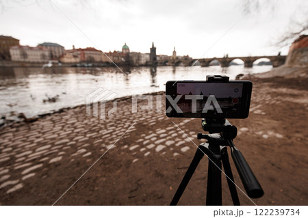 Smartphone recording time lapse of vltava river and charles bridge in prague Smartphone recording time lapse of vltava river and charles bridge in prague 122239734