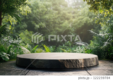 A circular stone platform is surrounded by lush, dense tropical foliage with various green leaves and some pink flowers, set in a misty, jungle-like environment. 122239784