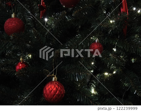 Christmas tree decorated with red ornaments and glowing lights in prague New Year preparation decor 122239999
