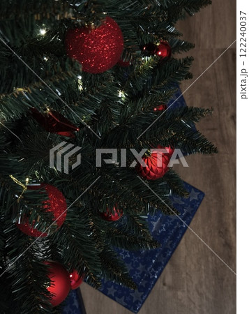 Christmas tree decorated with red ornaments and gifts underneath in prague Gift boxes New Year preparation decor Christmas tree decorated with red ornaments and gifts underneath in prague Gift boxes New Year preparation decor 122240037
