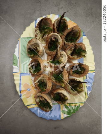 Christmas bread cups filled with sprats, pickles, and dill on festive plate in prague party food for aperitif, New Year's Eve dinner, Christmas or birthday Christmas bread cups filled with sprats, pickles, and dill on festive plate in prague party food for aperitif, New Year's Eve dinner, Christmas or birthday 122240056