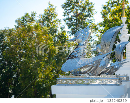 Silver swan statue at the entrance to the Thai temple. Thai art in the temple. Calm and believe. 122240259