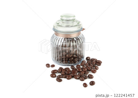 Chocolate dragees in a glass jar isolated on white. Chocolate dragees in a glass jar isolated on white. 122241457