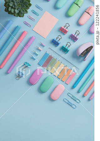 Stationery banner with markers, felt pens, paper clips, erasers, stickers in pastel colors on light blue background. A place for your text. Stationery banner with markers, felt pens, paper clips, erasers, stickers in pastel colors on light blue background. A place for your text. 122241856