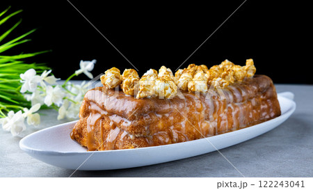 Cottage cheese casserole with raisins and caramel popcorn, poured with caramel sauce Cottage cheese casserole with raisins and caramel popcorn, poured with caramel sauce 122243041