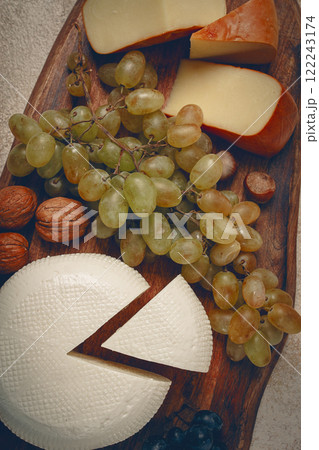 Georgian cheese, Imeretian and smoked suluguni, grapes, nuts, on a cutting board, Georgian cuisine, no people, 122243174