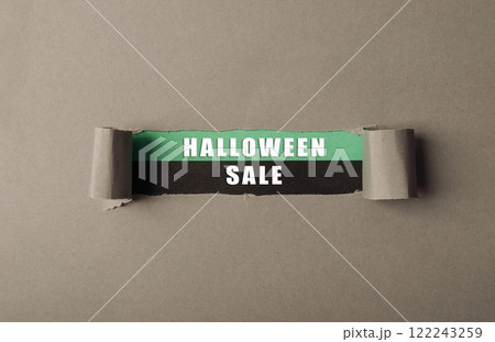 Sign for a Halloween sale is shown with a torn piece of paper Sign for a Halloween sale is shown with a torn piece of paper 122243259