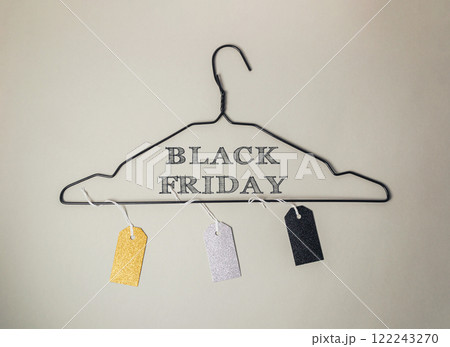Black and white sign hanging from a clothes hanger that says Black Friday Black and white sign hanging from a clothes hanger that says Black Friday 122243270