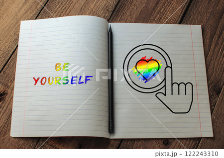 Notebook with a rainbow heart and the words be yourself written on it 122243310