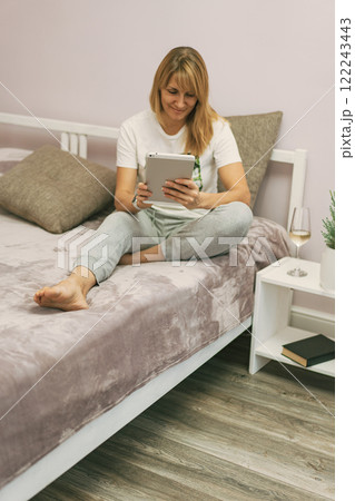 Woman sitting on the bed Woman sitting on the bed 122243443