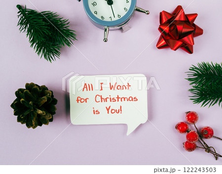 The sign is surrounded by various Christmas decorations, including a clock 122243503