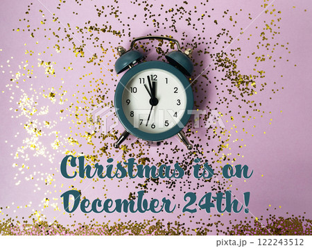 Clock with the time of 12:00 on it is on a purple background with gold glitter 122243512