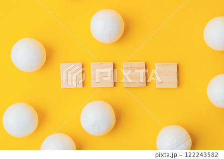 Wooden cubes with spheres on yellow background for minimalistic concept Wooden cubes with spheres on yellow background for minimalistic concept 122243582