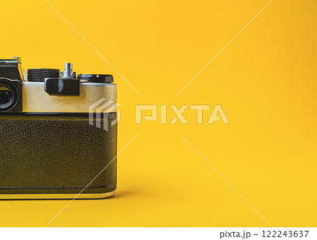 Retro camera on a yellow background with shadow play Retro camera on a yellow background with shadow play 122243637