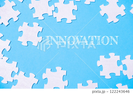 Puzzle pieces with innovation text on a blue background 122243646