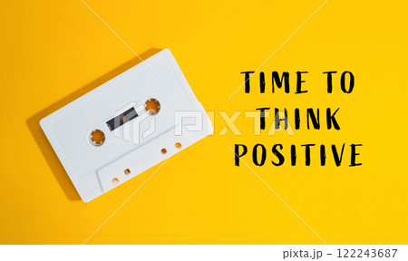 a yellow background with the words Time to Think Positive 122243687