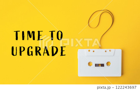 White cassette tape is hanging from a string with a question mark on it 122243697