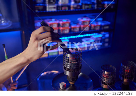 Close up of a hookah made of metal and glass on a wooden table Close up of a hookah made of metal and glass on a wooden table 122244158
