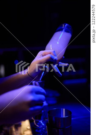 The Art of Crafting Unique Cocktails in a Cozy, Dimly Lit, and Inviting Bar Environment 122244579