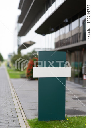 Modern signpost in front of a building Modern signpost in front of a building 122244781