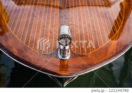 Glossy wooden boat deck with chrome light fixture Glossy wooden boat deck with chrome light fixture 122244790