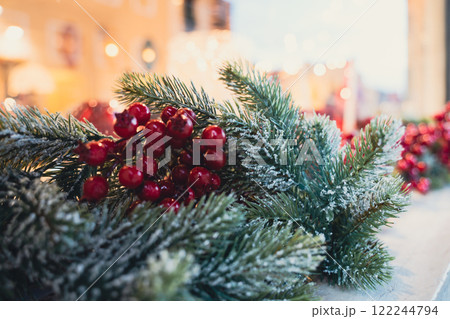 A holiday garland with frosted green branches and red berries A holiday garland with frosted green branches and red berries 122244794