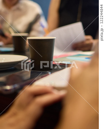 Join us for a meeting to foster engagement and innovation over coffee and important documents 122244844