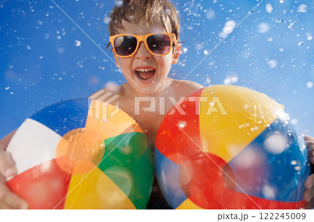Happy child playing in waterpark on summer vacation. 122245009