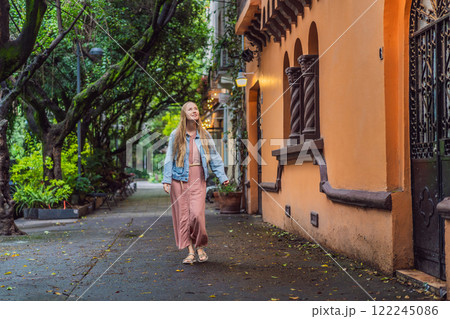 Woman tourist exploring lush streets of Condesa, Mexico City. Family adventure in a vibrant urban oasis. Travel, family bonding, and urban greenery concept in Latin America 122245086