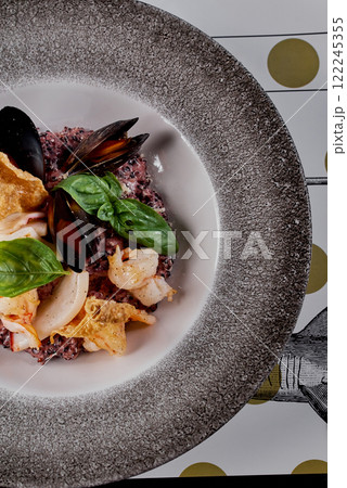 Close-Up of Seafood Risotto with Black Rice and Basil. Close-Up of Seafood Risotto with Black Rice and Basil. 122245355
