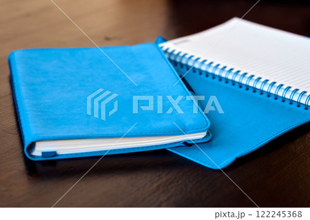Blue Leather Notebooks on Wooden Table. 122245368