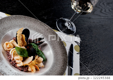 Seafood Risotto with Black Rice and Basil Garnish. 122245388