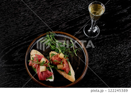 Prosciutto Crostini with Pear and Microgreens. 122245389