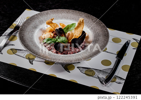 Seafood Risotto with Mussels and Basil on Decorative Plate. 122245391