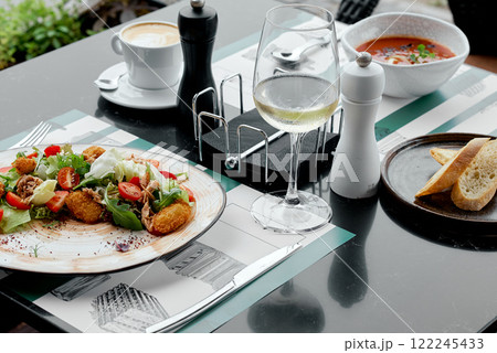 Fresh Salad with Cappuccino and Wine Glass. 122245433