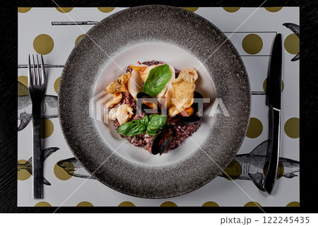 Seafood Risotto with Black Rice and Fresh Basil Leaves. Seafood Risotto with Black Rice and Fresh Basil Leaves. 122245435
