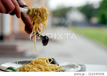 Hands Lifting Creamy Seafood Spaghetti. Hands Lifting Creamy Seafood Spaghetti. 122245436