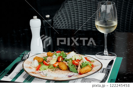 Fresh Salad with Tuna and Crispy Croquettes Served with White Wine. 122245458