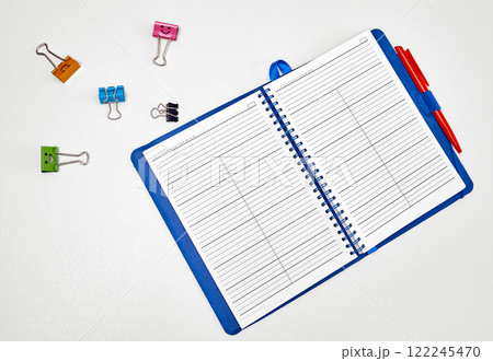 Open Planner with Binder Clips on White. 122245470