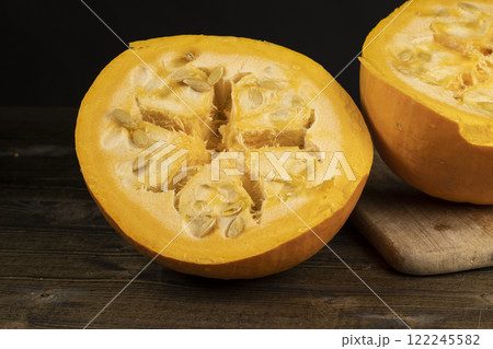 ripe orange pumpkin with seeds cut into pieces ripe orange pumpkin with seeds cut into pieces 122245582