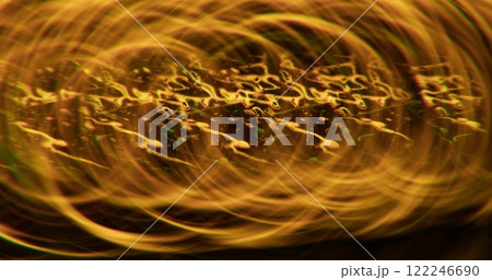 Sparkling liquid. Defocused glow. Golden yellow color lens flare gleaming flickers on art abstract blurred bokeh light background. 122246690