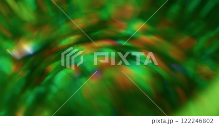 Bokeh green strobe. Round lens texture. Magnification festive flickering visual effect. Colored highlights smooth glass surface. Beam shimmer. 122246802