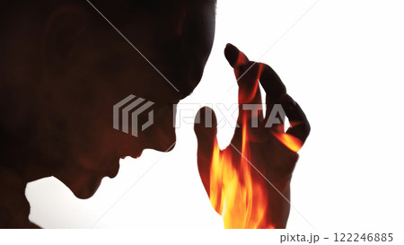 Emotional burnout. Disturbed silhouette. Pain pressure. Dark contrast double exposure profile outline of suffering woman in fire flames isolated on white copy space background. 122246885
