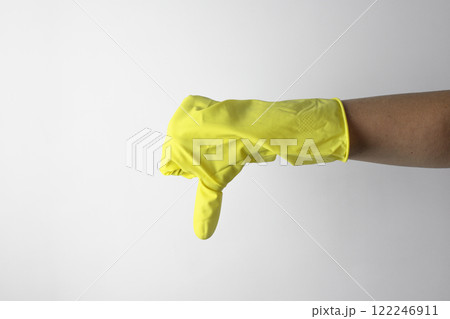 Housekeeping concept. Hand in yellow glove showing bad sign 122246911