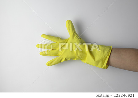 Cleaning concept. A hand in a yellow glove for cleaning 122246921