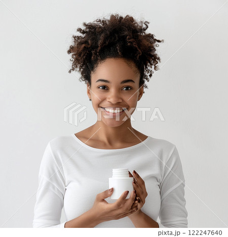 Smiling Woman Holding Open Cosmetic Jar Smiling Woman Holding Open Cosmetic Jar 122247640