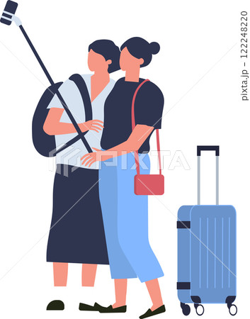 Two female tourists are taking a selfie with selfie stick while waiting for boarding at airport terminal, trolley suitcase is standing next to them 122248220