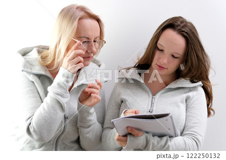 teacher student notebook helping girl in classroom for knowledge, helping schoolgirl and teach her to draw. Education concept 122250132