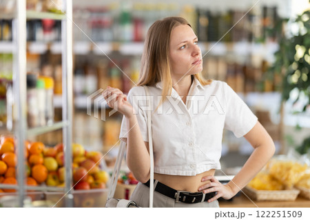 Young woman buyer forgot what she wanted to buy 122251509