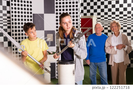 Portrait of family who is visiting lost room stylized under chessroom 122251718